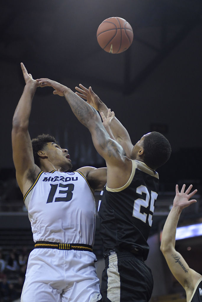 Missouri player Mark Smith attempts to shoot past Wofford player Messiah Jones